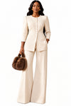 Woman wearing a coordinated beige blazer and pants set.